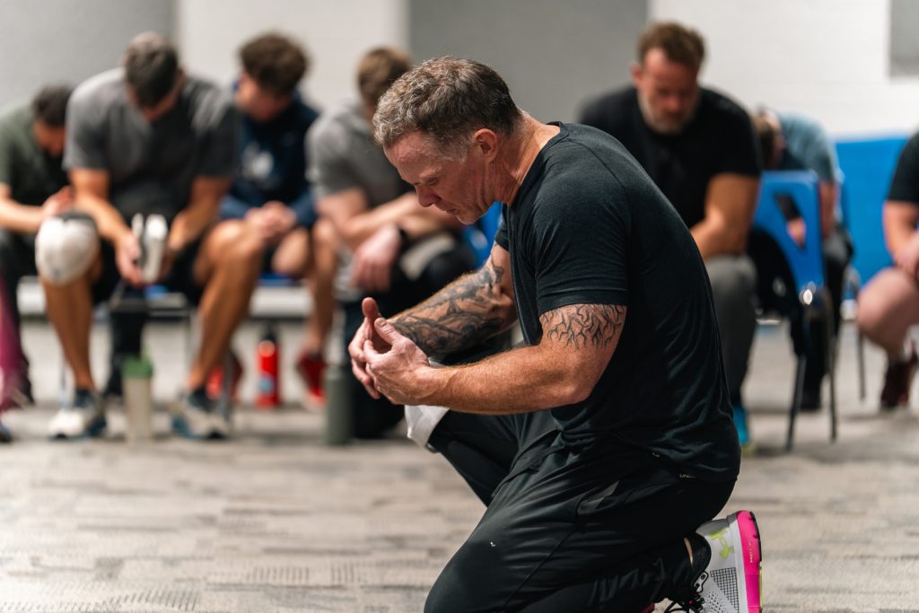 Christian men praying together for strength and faith