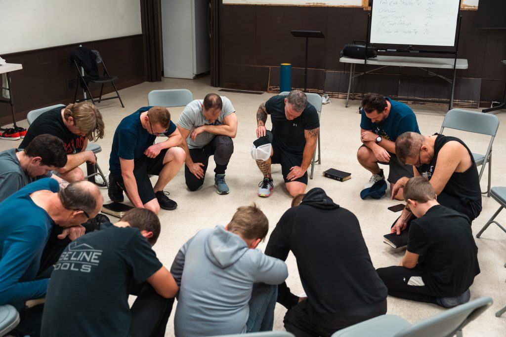 Men’s ministry prayer circle at Forged 27:17