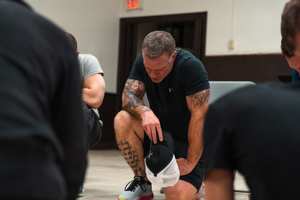 Christian men praying together for strength and faith
